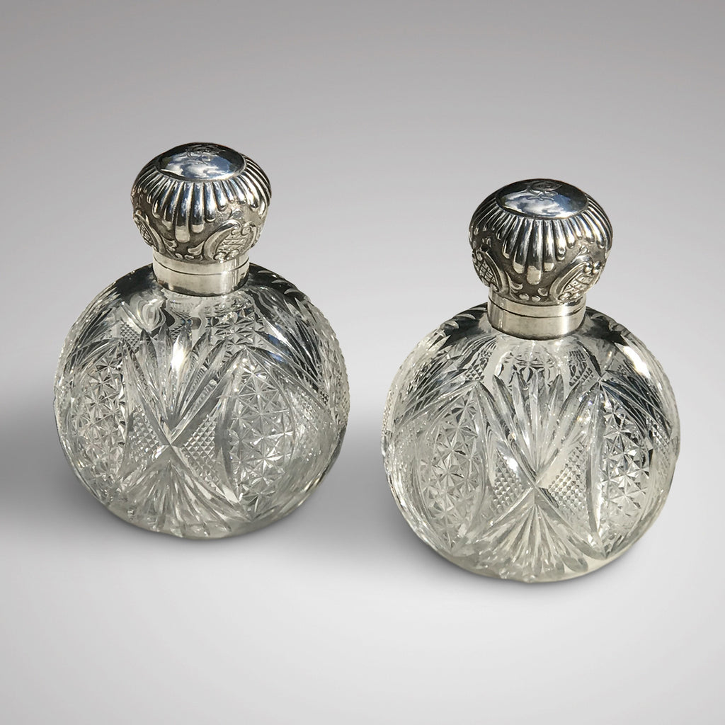 A Pair of Antique Silver Topped Scent Bottles
