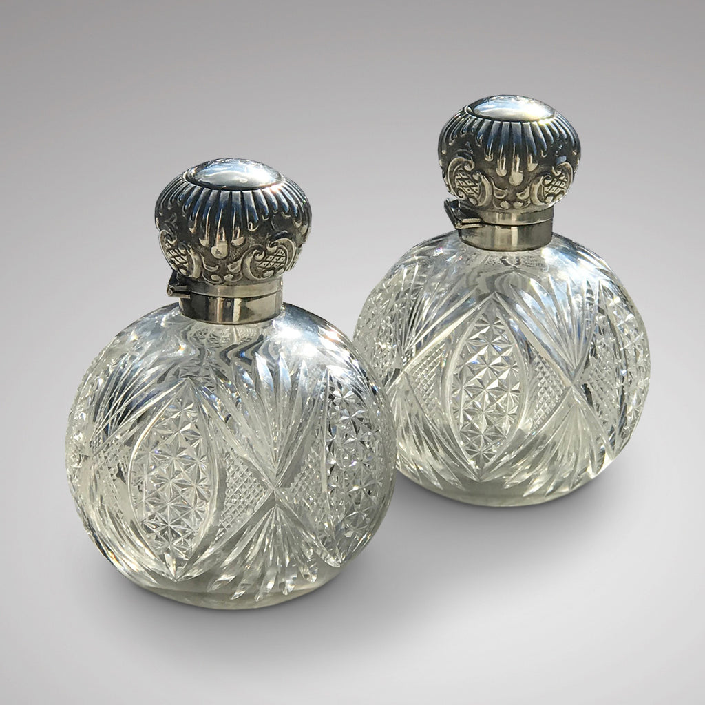 A Pair of Antique Silver Topped Scent Bottles